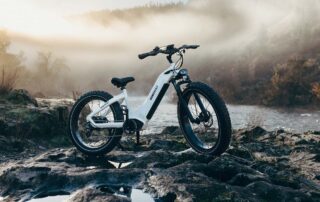 Electric Bike Standing on Rocks Crossing River