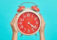 Two hands Holding Big Alarm Clock Two Hands Holding Big Alarm Clock