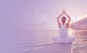 Person doing Yoga on a Boardwalk Over a Lake