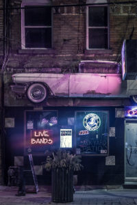 Old Car Mounted Against Side of Building