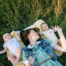 Mother Laying with Babies on a Blanket on the Grass