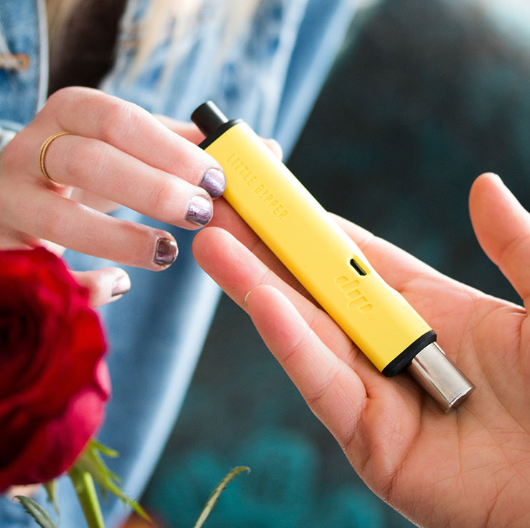 Person Handing Someone a Yellow Vape