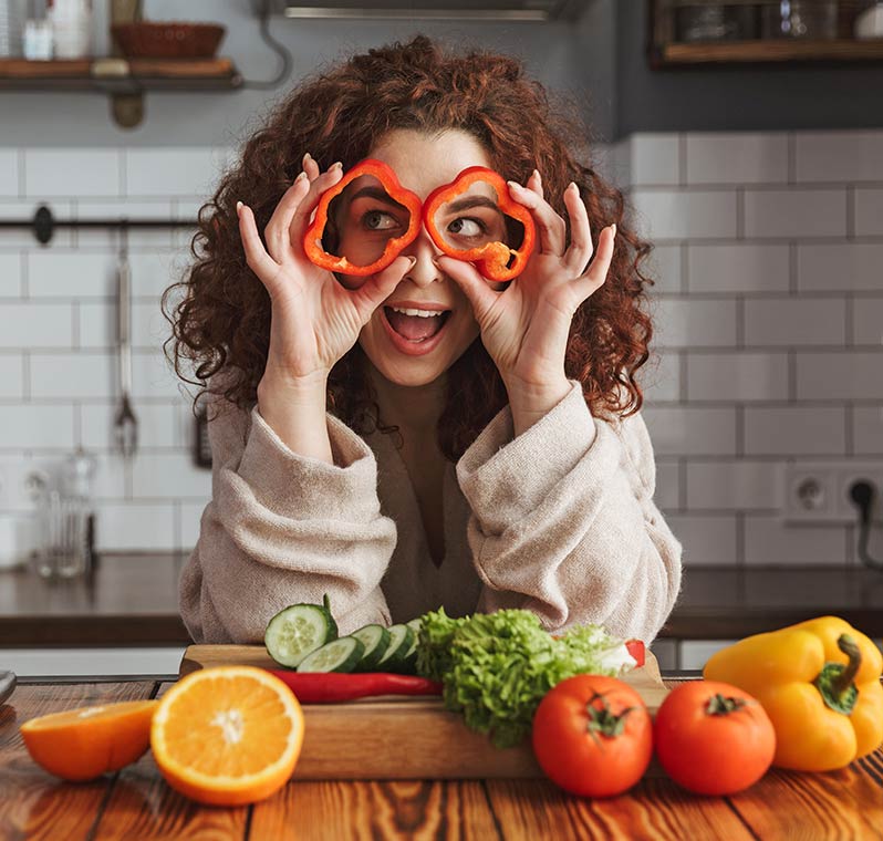 Woman Holding Bell Pepper Circles in Front of Eyes